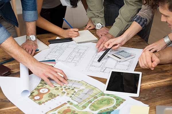 group of people looking at landscaping drawings