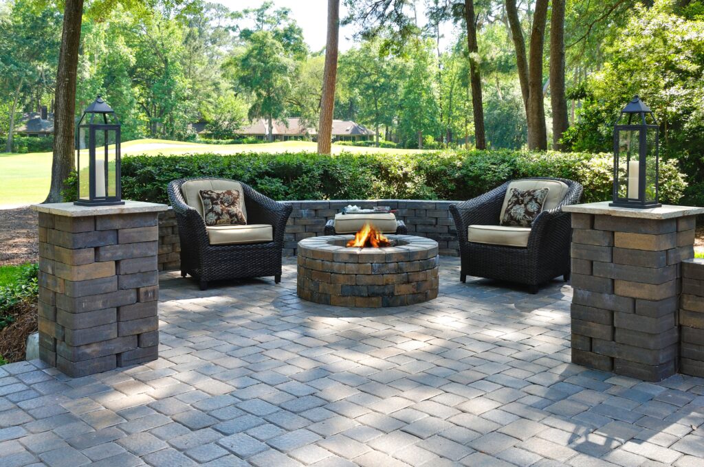 Paver patio installed by Creative Outdoor Design with a fire pit and luxurious design for furniture.